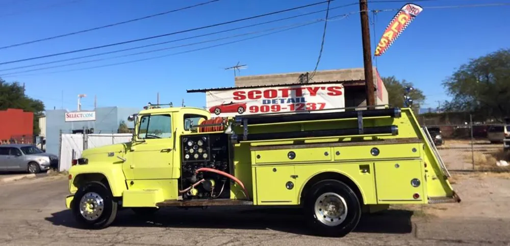 Vintage red fire truck under the Scotty's Detail banner